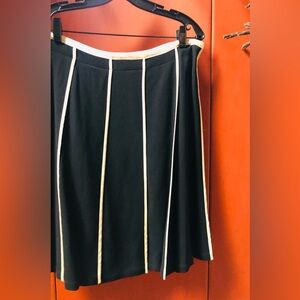 Gorgeous DKNY wool blend black pleated skirt with off white accents!